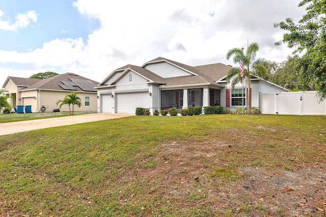 view of front of house featuring a garage and a front lawn