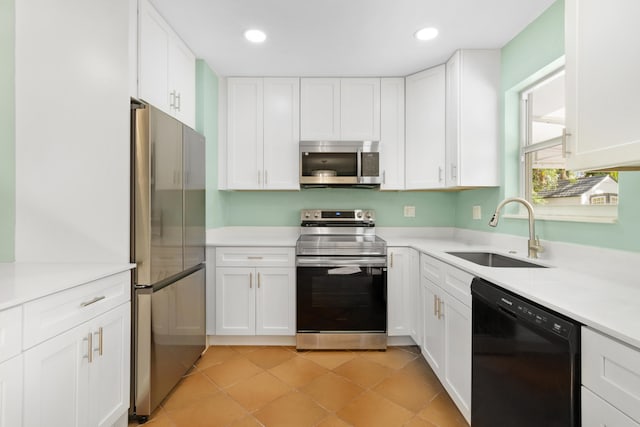 kitchen with sink, appliances with stainless steel finishes, and white cabinets