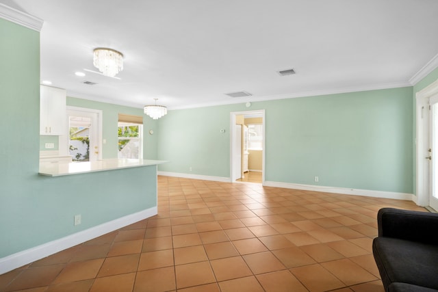 living room with ornamental molding, light tile patterned flooring, and an inviting chandelier