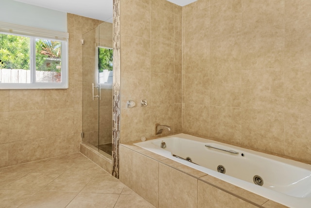 bathroom featuring plus walk in shower, tile patterned floors, and tile walls