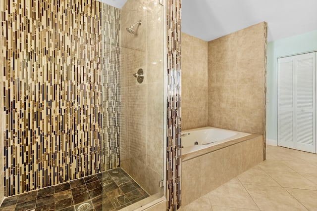 bathroom with plus walk in shower, tile walls, and tile patterned flooring