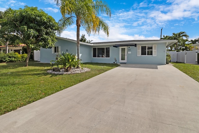 single story home with driveway, stucco siding, a gate, fence, and a front yard