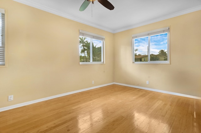 spare room featuring crown molding, a healthy amount of sunlight, light wood-type flooring, and ceiling fan