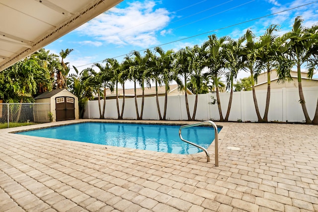 view of pool with a patio and a storage unit