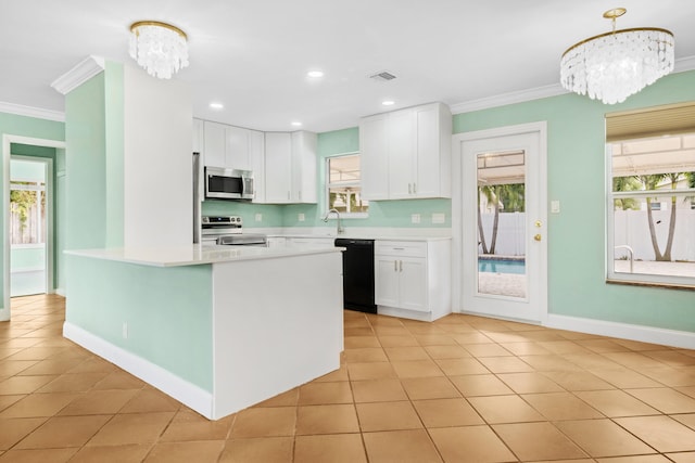 kitchen with decorative light fixtures, white cabinets, stainless steel appliances, and a chandelier