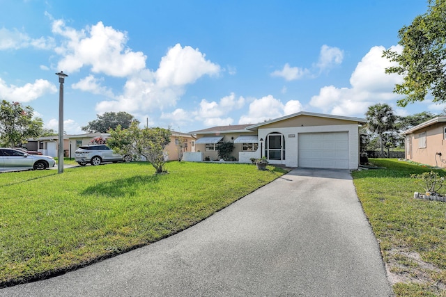 ranch-style house featuring a front lawn and a garage