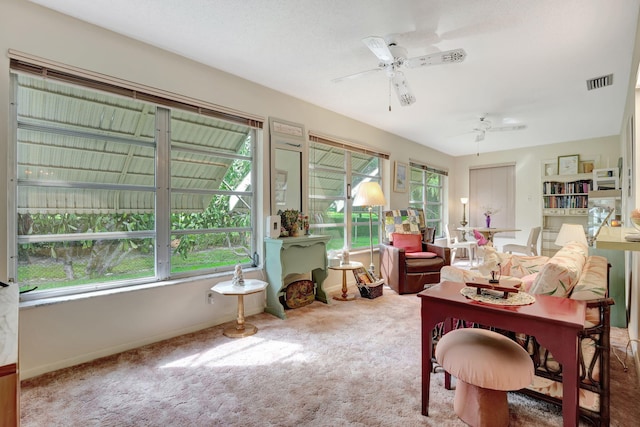 sunroom / solarium with ceiling fan and plenty of natural light