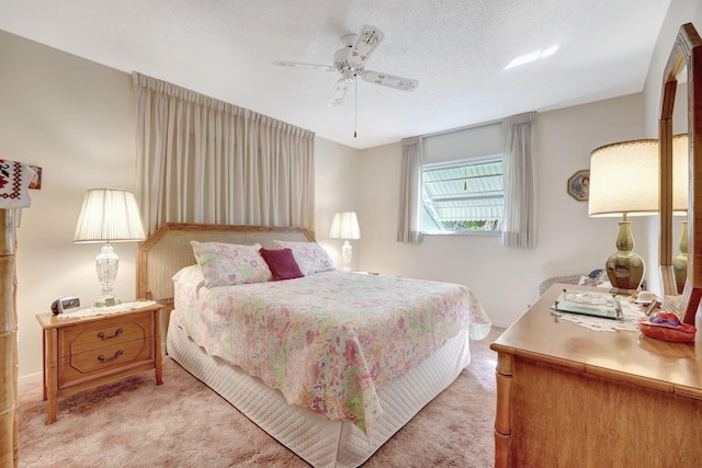 carpeted bedroom featuring a textured ceiling and ceiling fan