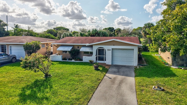 single story home featuring a front lawn and a garage