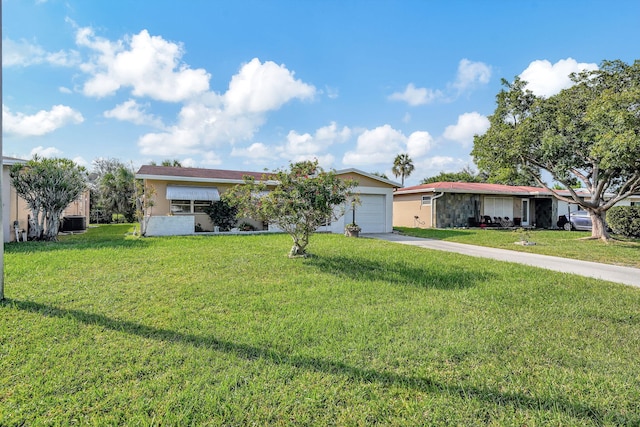 single story home with a front yard and a garage