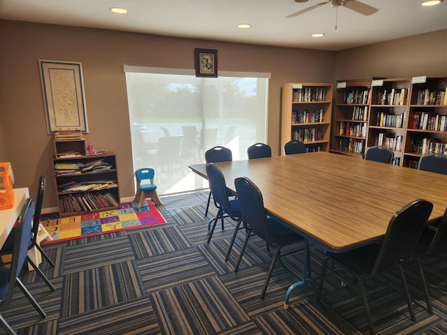 interior space featuring ceiling fan and dark colored carpet