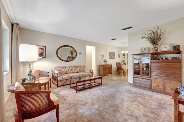 living room with a chandelier and light colored carpet