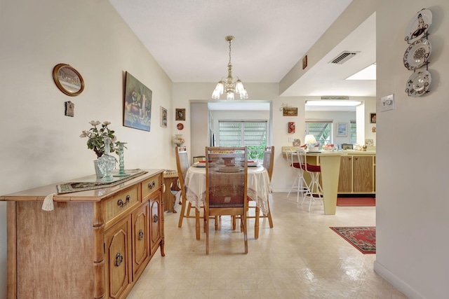 dining space featuring a chandelier