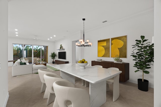 tiled dining room featuring ceiling fan with notable chandelier and crown molding