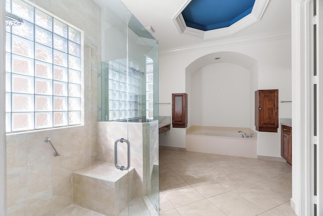 bathroom featuring tile patterned floors, vanity, crown molding, and plus walk in shower