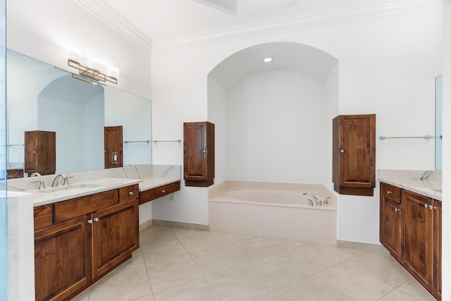 bathroom featuring a bathing tub, crown molding, tile patterned flooring, and vanity