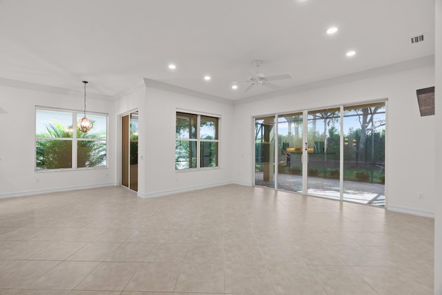 tiled empty room with ceiling fan with notable chandelier and ornamental molding