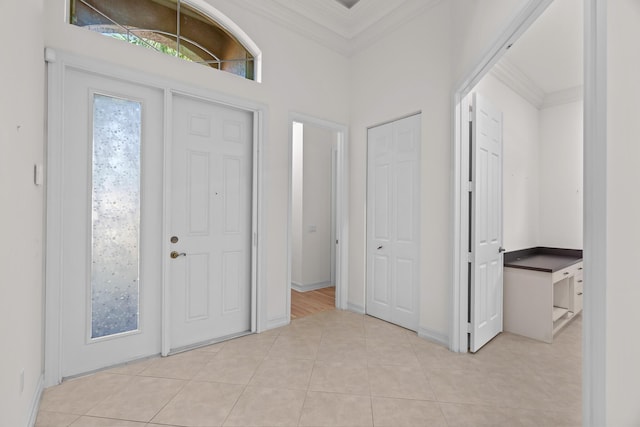 tiled entrance foyer with ornamental molding