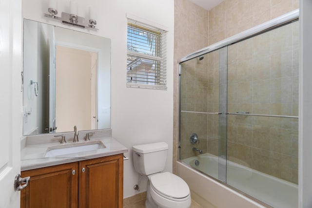 full bathroom with shower / bath combination with glass door, vanity, and toilet