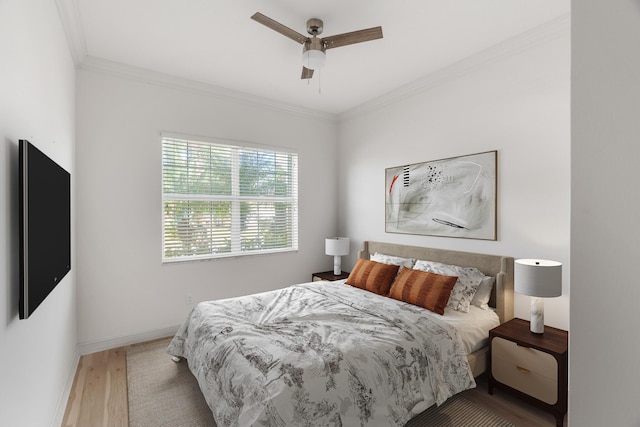 bedroom with ceiling fan, ornamental molding, and hardwood / wood-style flooring