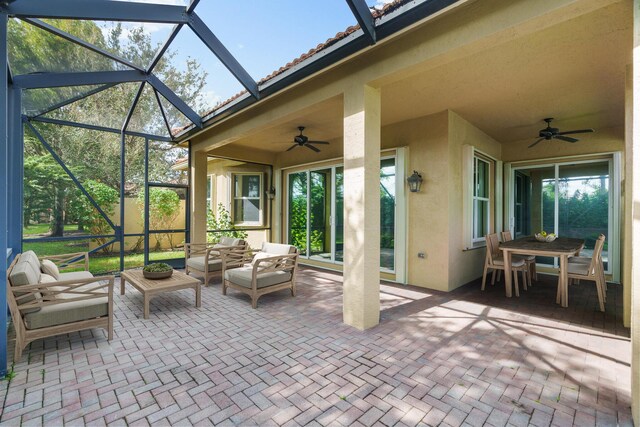 view of patio / terrace featuring a lanai, ceiling fan, and an outdoor hangout area