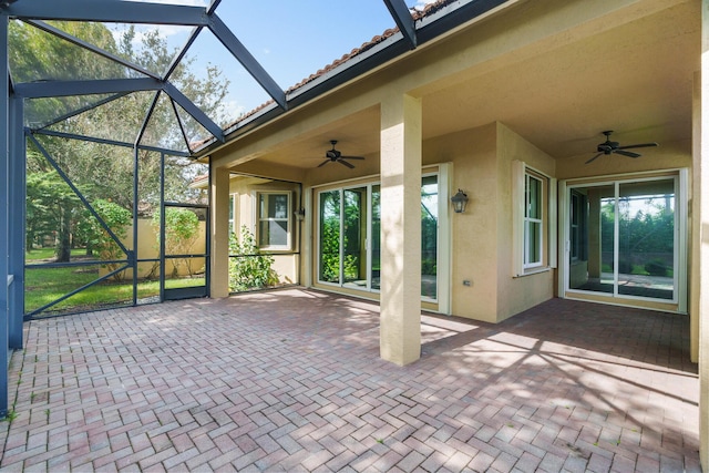 unfurnished sunroom featuring ceiling fan