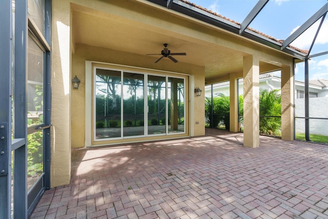 view of patio featuring ceiling fan and a lanai