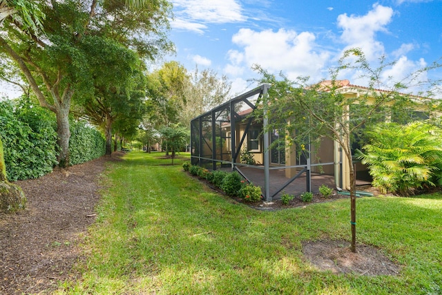 view of yard featuring a patio and glass enclosure