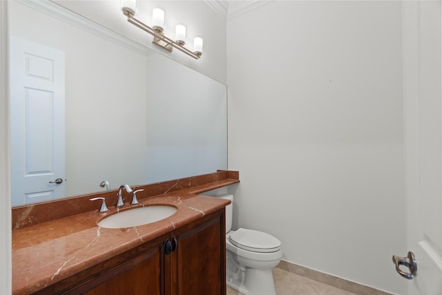 bathroom with tile patterned floors, toilet, vanity, and ornamental molding