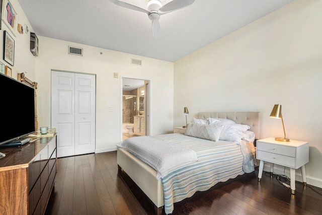 bedroom featuring ceiling fan, dark hardwood / wood-style flooring, connected bathroom, and a closet