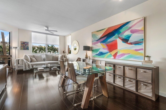 dining room with dark hardwood / wood-style floors, ceiling fan, and a textured ceiling