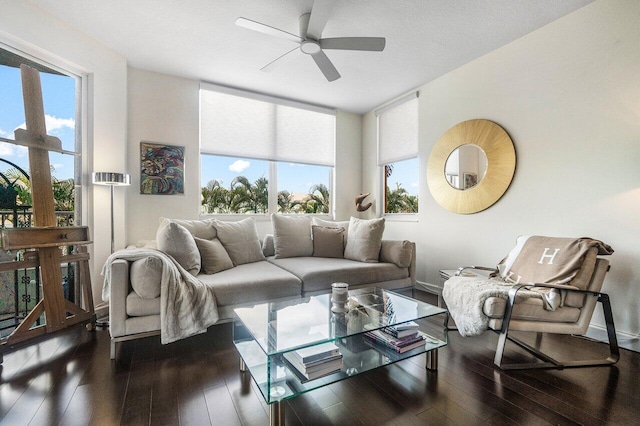 living room with plenty of natural light, ceiling fan, and dark hardwood / wood-style flooring