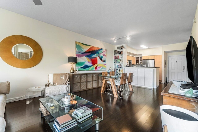 living room featuring a textured ceiling and dark hardwood / wood-style floors