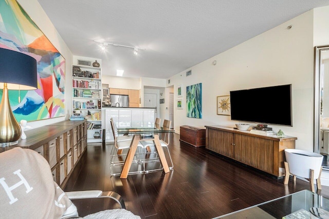 rec room with dark wood-type flooring and a textured ceiling