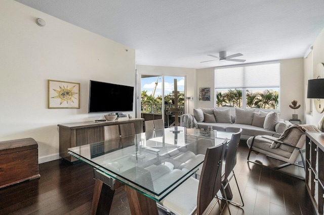 dining room with a textured ceiling, ceiling fan, and dark hardwood / wood-style floors