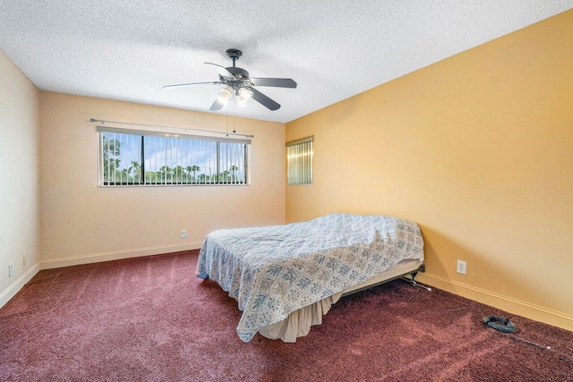 bedroom featuring a textured ceiling, carpet flooring, and ceiling fan