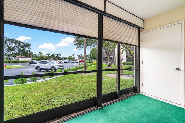 doorway to outside featuring carpet flooring