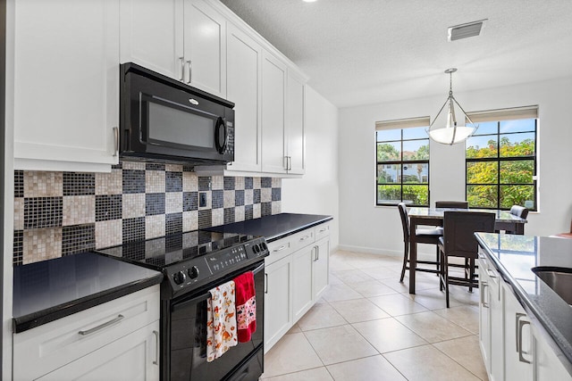 kitchen featuring white cabinets, decorative light fixtures, decorative backsplash, light tile patterned flooring, and black appliances