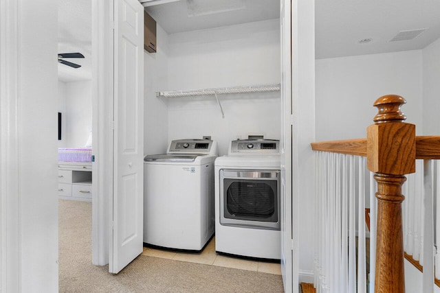 washroom featuring light tile patterned flooring and washing machine and clothes dryer