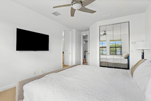 carpeted bedroom with a closet and ceiling fan