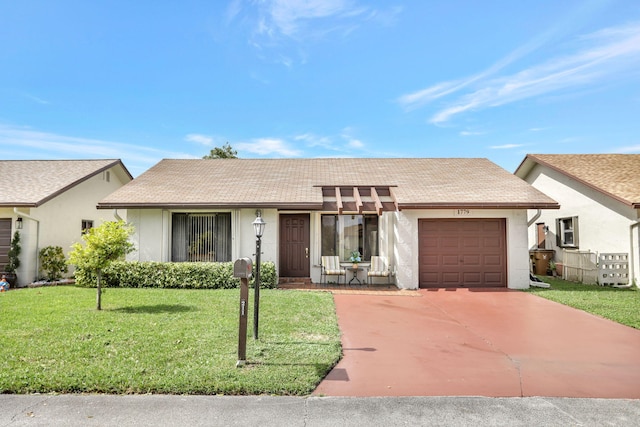 ranch-style home featuring a garage and a front lawn