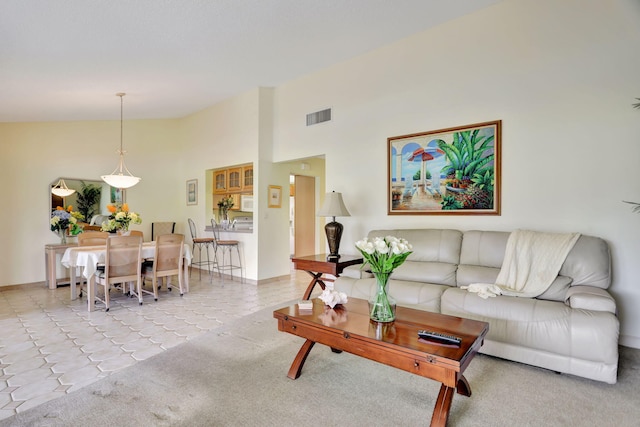 tiled living room with high vaulted ceiling