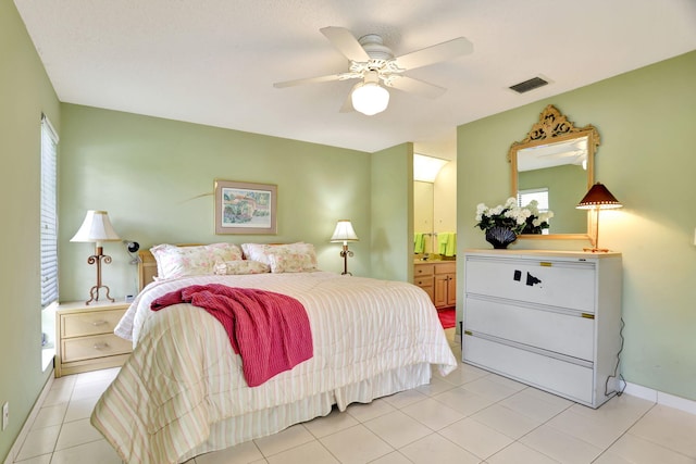 bedroom featuring multiple windows, ensuite bathroom, light tile patterned flooring, and ceiling fan