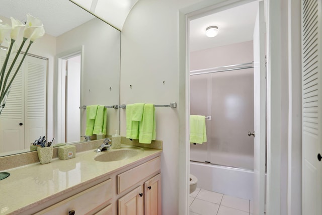 full bathroom featuring vanity, toilet, tile patterned floors, and enclosed tub / shower combo