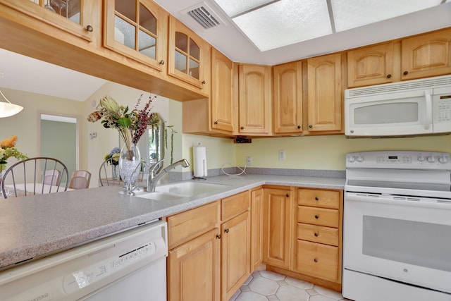 kitchen featuring sink, light brown cabinets, white appliances, and light tile patterned flooring