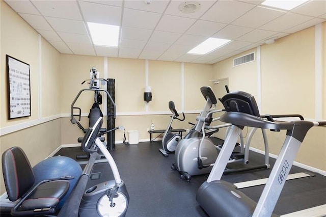 exercise room featuring a paneled ceiling