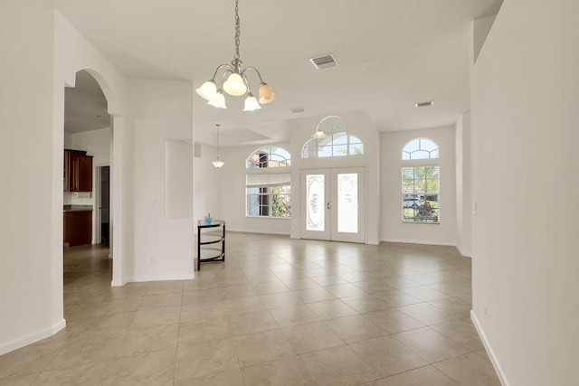 interior space featuring an inviting chandelier and french doors