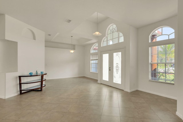 foyer featuring french doors and light tile patterned floors