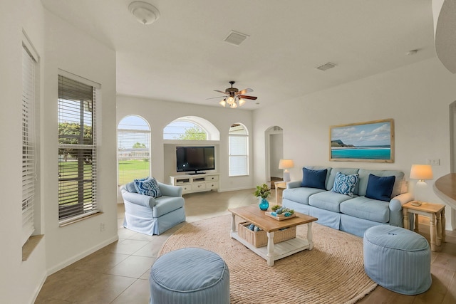 living room featuring light tile patterned flooring, ceiling fan, and plenty of natural light