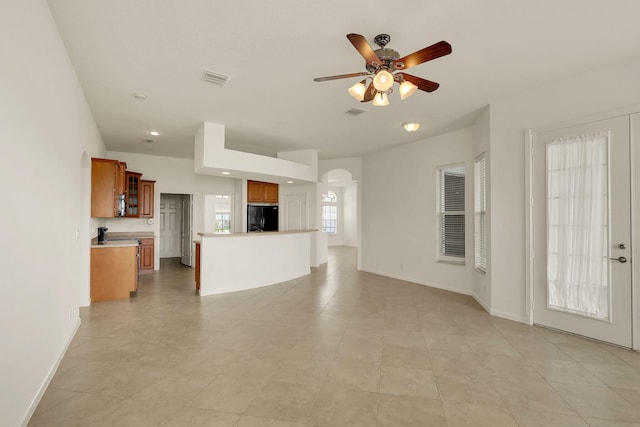 unfurnished living room with ceiling fan and light tile patterned floors